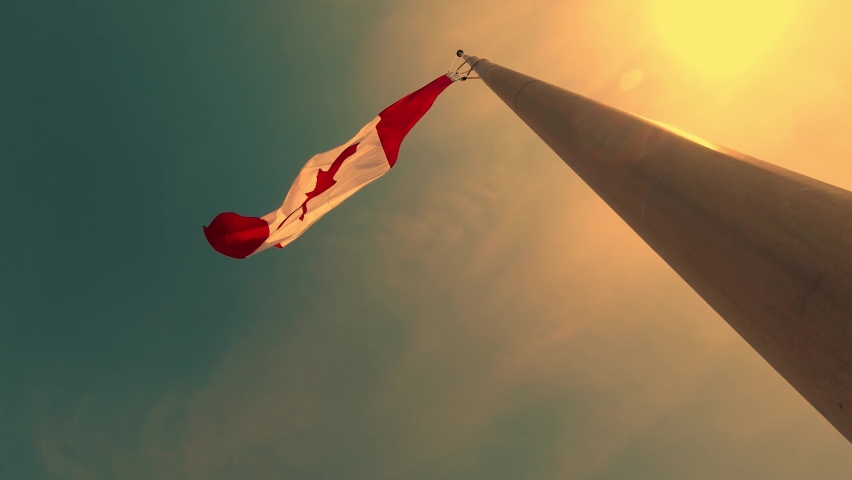 Canadian flag slow motion at half mast at Toronto city Ontario Canada. In remembrance of a tragedy. Half-masting the National Flag of Canada. Flag lowered and express a collective sense of sorrow. Royalty-Free Stock Footage #1074983561