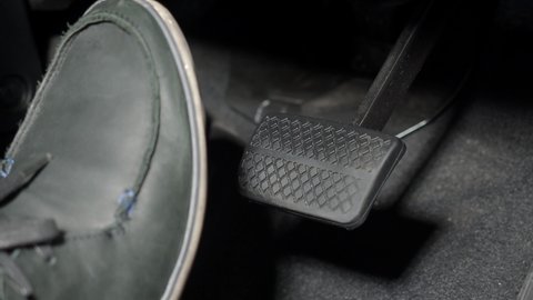Car foot pedal. Accelerator and break pedal in a car. Close up the foot pressing foot pedal of a car to drive. Driver driving the car by pushing accelerator pedals of the cars. inside vehicle. auto.