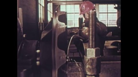 CIRCA 1960 - Men create steel pieces at a fabricating works facility.