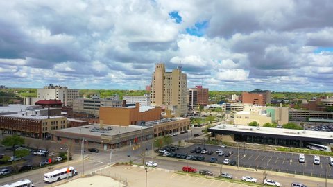 FLINT, MICHIGAN - CIRCA 2020s - Good drone aerial of downtown Flint, Michigan with old buildings and empty lots, suggesting economic downturn.