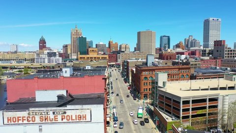 MILWAUKEE, WISCONSIN - CIRCA 2020s - Aerial establishing shot of downtown Milwaukee Wisconsin business district, Milwaukee River and skyscrapers.