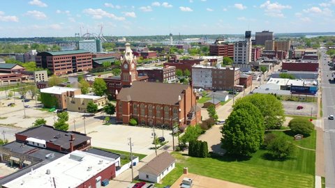 MOLINE ILLINOIS - CIRCA 2020s - Drone aerial establishing shot of downtown business district Moline Illinois on the Mississippi River.