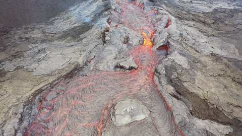 ICELAND - CIRCA 2020s - Aerial of hot molten lava flowing in a river from Fagradalsfjall volcano on the Reykjanes Peninsula in Iceland.