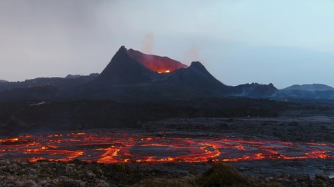 ICELAND - CIRCA 2020s - Ground level shot of Iceland Fagradalsfjall volcano eruption with molten lava fields in motion foreground.