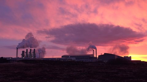 ICELAND - CIRCA 2020s - Establishing shot at sunset of a geothermal power plant producing clean energy in iceland.