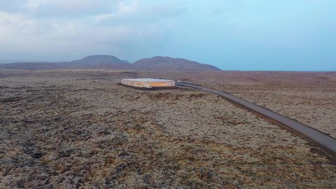 ICELAND - CIRCA 2020s - Very good aerial establishing shot of a remote geothermal experimental greenhouse in a lonely section of Iceland.