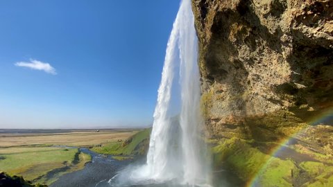 ICELAND - CIRCA 2020s - Establishing shot of the beautiful Seljalandsfoss waterfall in South Iceland.