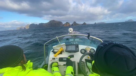 ICELAND - CIRCA 2020s - Icelandic search and rescue coast guard brave very high seas in a zodiac boat and high waves in the Westman Islands, Iceland.