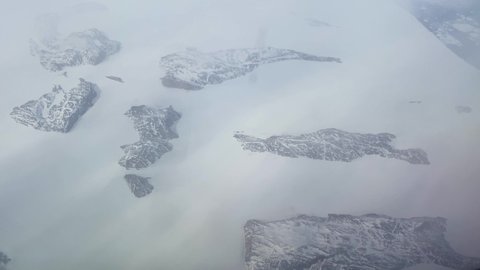 GREENLAND - CIRCA 2020s - Good aerial over the Greenland ice sheet as it is breaking up due to global warming.