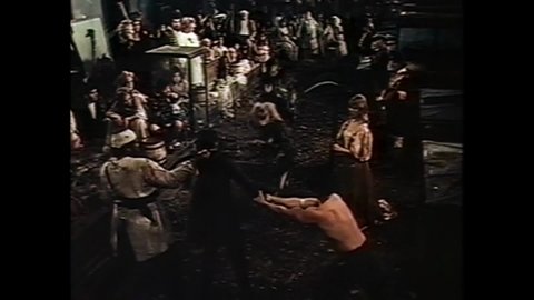 CIRCA 1973 - In this horror film, inmates take over an asylum and imitate chickens while threatening the doctor with scythes.