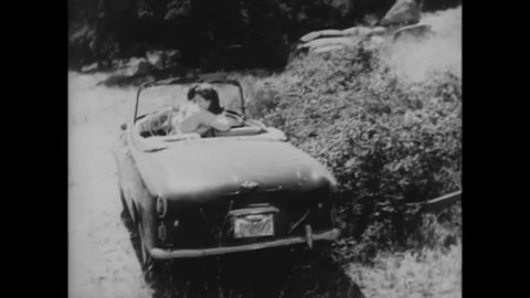 CIRCA 1964 - In this horror film, a large, furry monster eats a young couple out of their convertible.