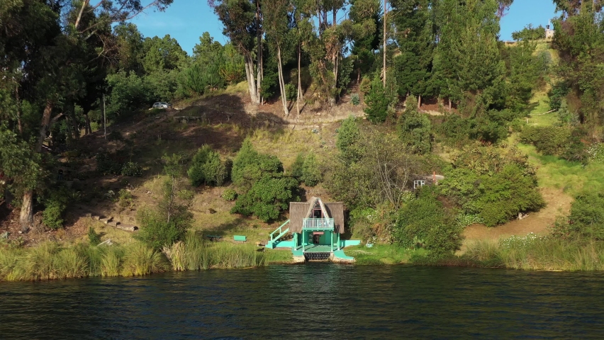 Aerial View of Small House on Laguna De Tota Lakefront, Boyaca, Colombia. Scenic Landscape of Largest Colombian Lake, Revealing Drone Shot
