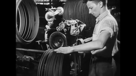 CIRCA 1930s - Men begin the process of making rubber tires at a manufacturing plant.