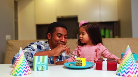 single father and his little daughter celebration birth day in kitchen