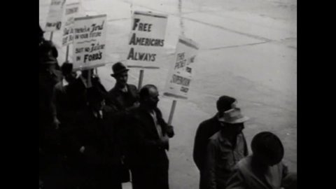 CIRCA 1930s - Ford workers on strike carry protest signs about scabs and worker's rights.