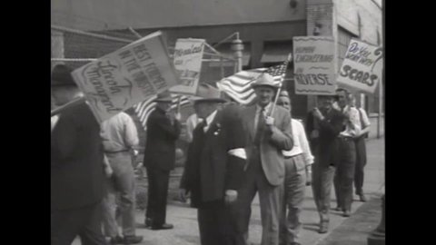 CIRCA 1930s - Factory workers picket with protest signs about scabs.