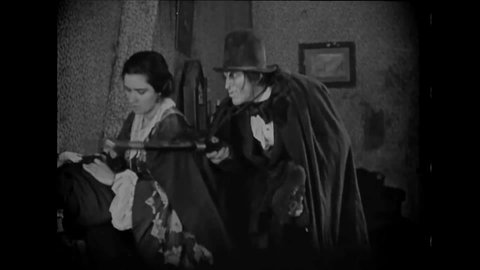 CIRCA 1920 - In this silent horror movie, Mr. Hyde kicks out his kept woman.