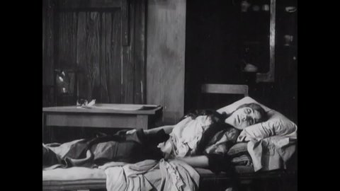CIRCA 1909 - In this silent film, Edgar Allan Poe brings groceries to his dying lover and wails over her body.