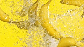 Super slow motion of bananas hitting in the air on yellow background. Filmed on high speed cinema camera. - Powered by Shutterstock - Get 15% off with code: PIKWIZARD15
