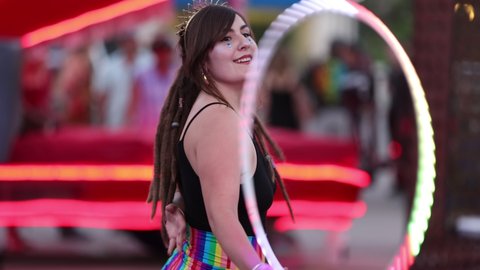 Reno, NV - USA - June 26 2021: Street Performer with Colorful Lit Hula Hoop at the Sierra Arts Festival in Downtown.  Shallow Depth of Field