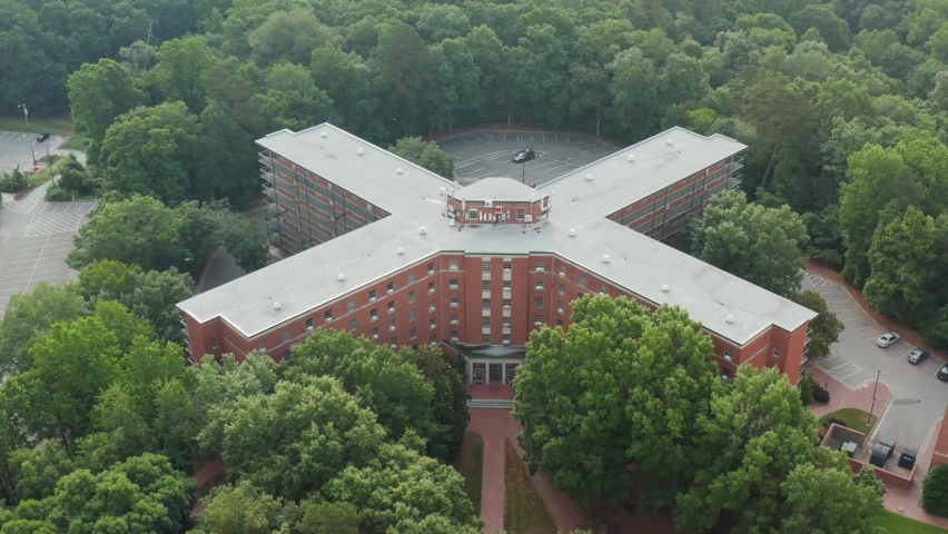 Large college, university dormitory. Dorm, residence life at campus. Apartment housing. Aerial view of sprawling building.