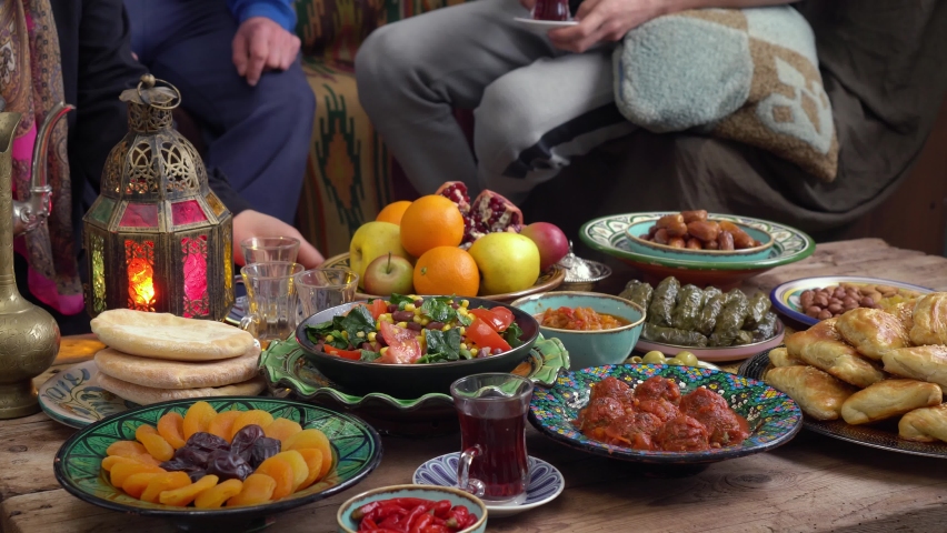 Eid al-Adha or the Feast of Sacrifice. Happy authentic arabic muslim family have a dinner at home together. Concept of religion, lifestyle, stay at home, lockdown, family | Shutterstock HD Video #1075025447