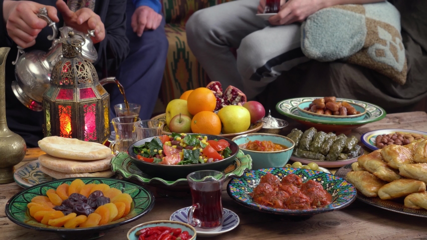Eid al-Adha or the Feast of Sacrifice. Happy authentic arabic muslim family have a dinner at home together. Concept of religion, lifestyle, stay at home, lockdown, family | Shutterstock HD Video #1075025447