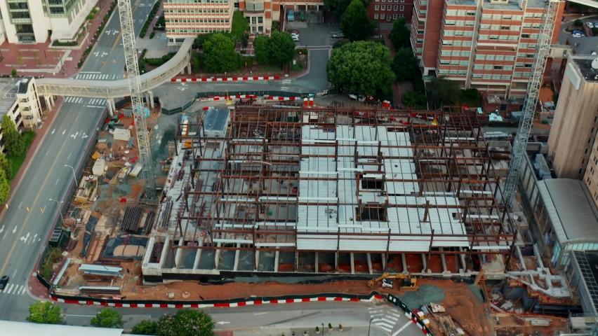 Medical research hospital under construction at UNC Chapel Hill. Heavy cranes and equipment revealed by aerial tilt up.