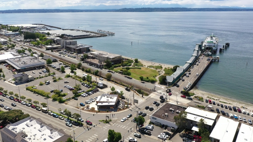 Cinematic 4K drone footage of the downtown Edmonds commercial area, loading ferry at the Kingston terminal, waterfront marina, near Seattle, Pacific Northwest, in Snohomish County