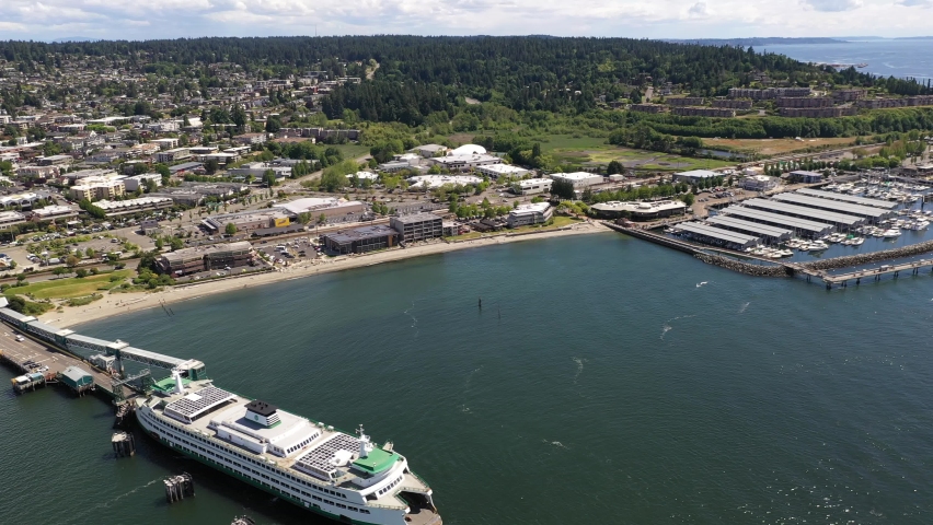 Cinematic 4K drone footage of the downtown Edmonds commercial area, Kingston ferry at the waterfront terminal, Sunset beach, marina, near Seattle, Washington, Pacific Northwest, in Snohomish County