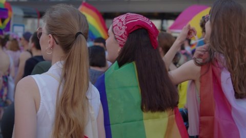 Warsaw, Poland, 19.06.2021 Pride parade. Women with colorful clothes and rainbow flags marching for the lgbtq rights
