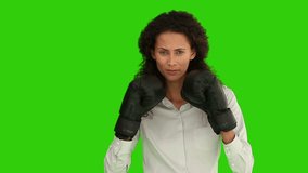 African-american woman with boxing  gloves against a green screen