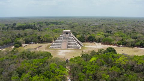 Forwards reveal of famous landmark Temple of Kukulcan. Aerial view of old stone pyramid. Historical monuments of pre-Columbian era, Chichen Itza, Mexico.