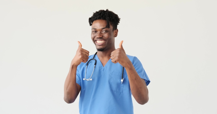 Male doctor giving thumbs up over white background