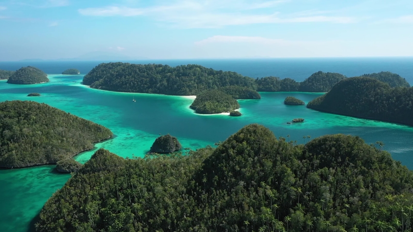 RAJA AMPAT, INDONESIA - CIRCA 2020s - 2020 - Excellent sweeping aerial shot of the Wayag Islands, Raja Ampat, Indonesia.