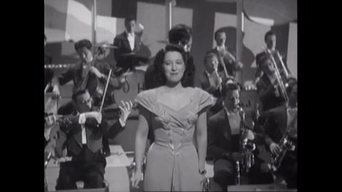 CIRCA 1942 - In this musical, a woman concludes singing "You Made Me Love You (I Didn't Want to Do It)" with Harry James' orchestra at a nightclub.