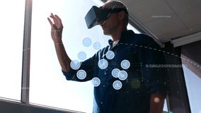 Animation of network of connections with icons over man wearing vr headset. global connections and technology concept digitally generated video.