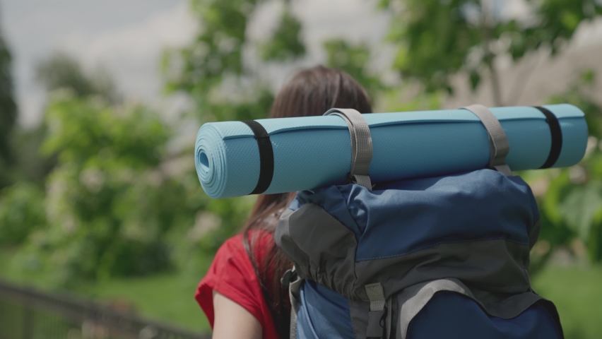 Girl traveler millennial with blue backpack and yoga mat travels, explore local attractions, active woman in search of adventure, happy life, hiking vacation, enjoy nature outdoors, slow motion | Shutterstock HD Video #1075081052