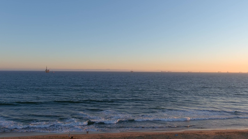 Aerial Video of Huntington Beach during sunset. Camera slowly scrolls right.