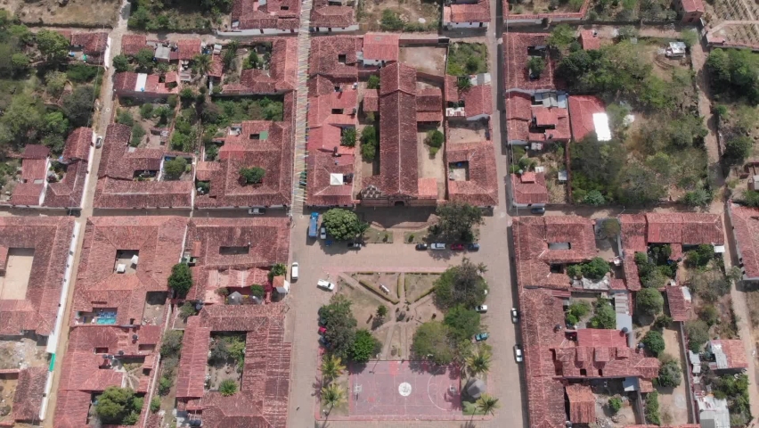 Jib up in zenith view above central park and church in a village
