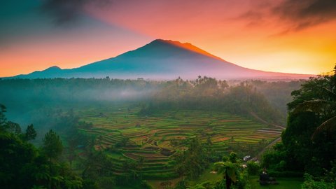 Volcano Gunung Agung or Mount Agung - the highest mountain Bali on background scenery rice terraces. Volcano Agung is one of the most recognizable landmark island Bali. 8K 
