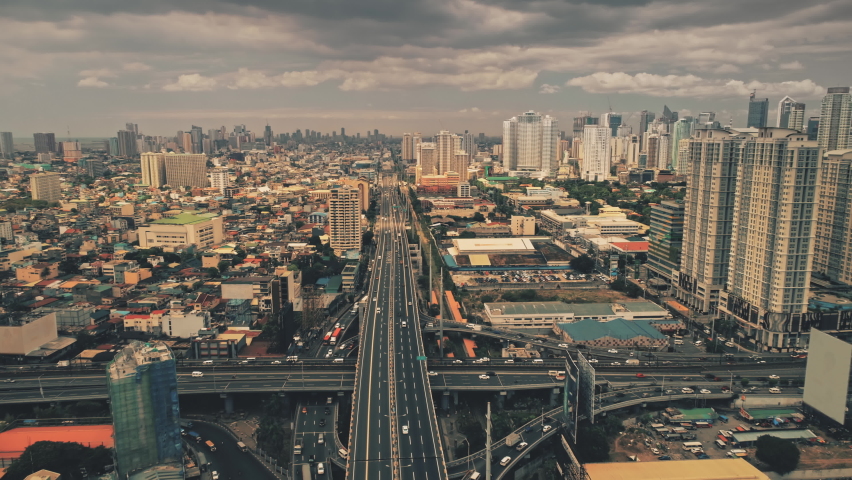 Aerial view transport moves along city road. Giant metropolis, modern skyscrapers. Gray tint to dramatic cloudy sky. Futuristic real estate in downtown Seoul. Time interval. South Korea
