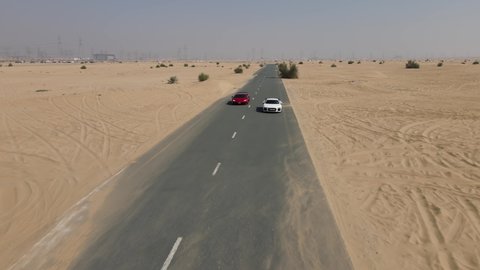Lamborghini and Audi sports cars racing on a desert road. UAE Dubai 2021.06.06