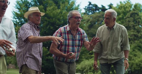 Portrait of Cheerful Senior Retired Friends Having Fun, Playing a Friendly Game of Boules and Laughing Together in the Park. A Group of Elderly Being Active and Enjoying the Good Summer Weather  स्टॉक व्हिडिओ