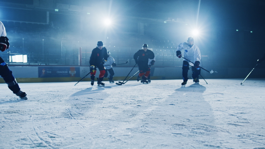 Ice Hockey Rink Arena: Successful Pass for Forward Player who Does Slapshot, Shots Puck with Stick and Scores a Goal with a PowerWide Hit. Goals Off Camera. Cinematic Slow Motion Wide Shot Royalty-Free Stock Footage #1075109693