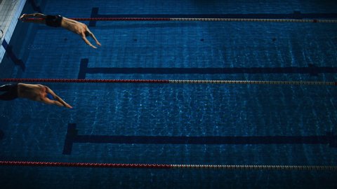 Swim Race: Two Professional Swimmers jump dive in Swimming Pool. Athletes Compete the Best Wins Championship. Slow Motion, Aerial Top View Tracking Shot. Dark Dramatic Colors, Cinematic Lap Lane Light