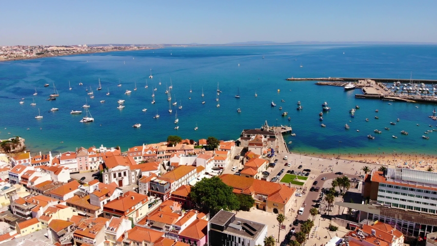 Ocean view in Cascais, Portugal. Many sailboats in one place, a view from a height. European houses with red tiles from a height.