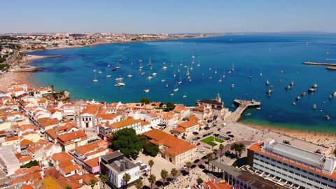 Ocean view in Cascais, Portugal. Many sailboats in one place, a view from a height. European houses with red tiles from a height.