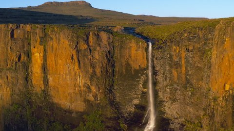 Spectacular aerial view of a tourist standing and admiring the magnificent beautiful Tugela Falls, second highest waterfall in the world,Drakensberg,South Africa. Fresh pure Water 