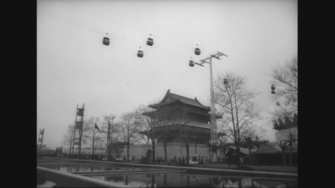 CIRCA 1964 - Visitors walk past pavilions for Hong Kong, Pakistan, Japan, Thailand, India, Berlin, and Hollywood at the New York World's Fair.